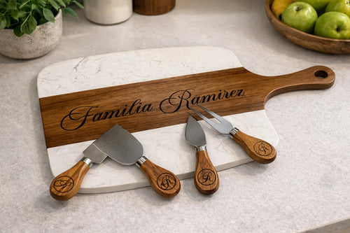 Personalized marble and acacia charcuterie board set with engraved family name and matching serving tools.